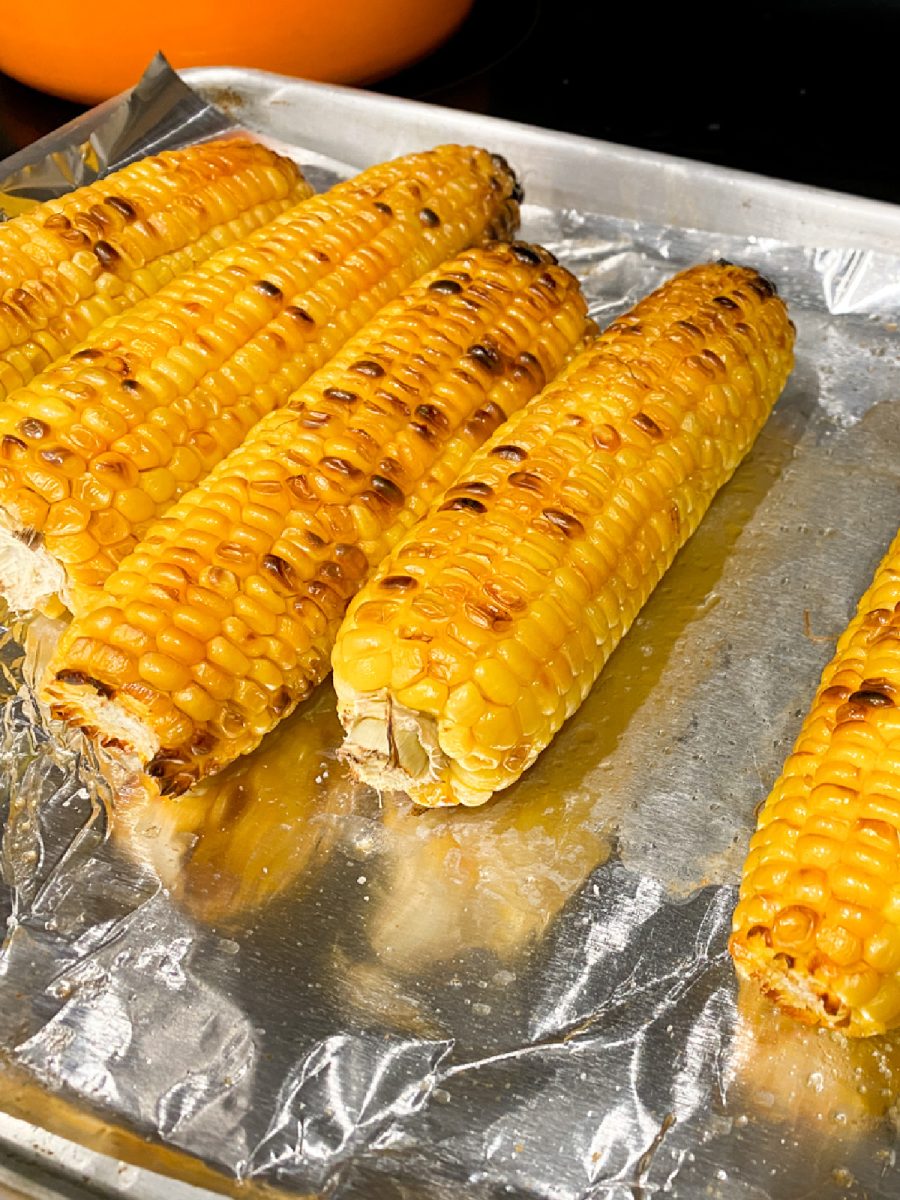 char-broiled corn on baking sheet