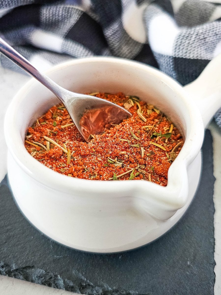 close up of seasonings with spoon in bowl