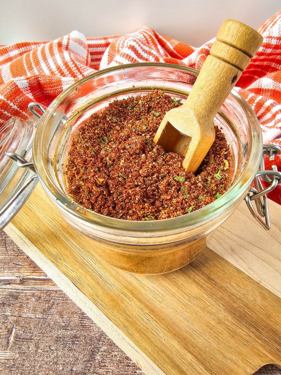 close up of spices for elote with wooden spoon