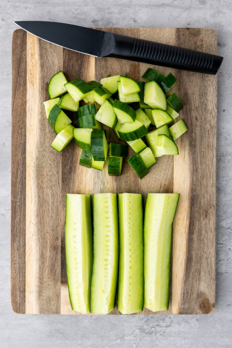 dicing cucumbers on cutting board