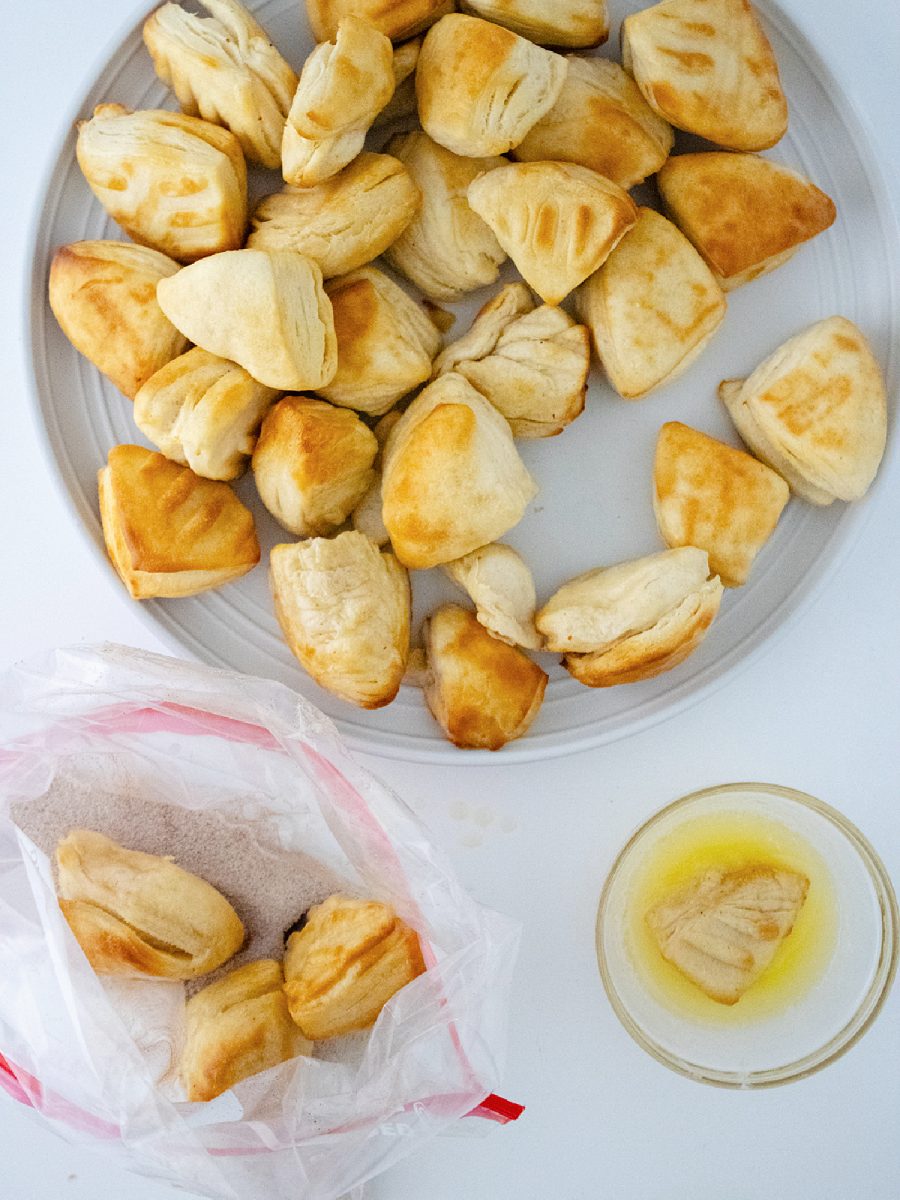 dip donut holes into butter and cinnamon sugar