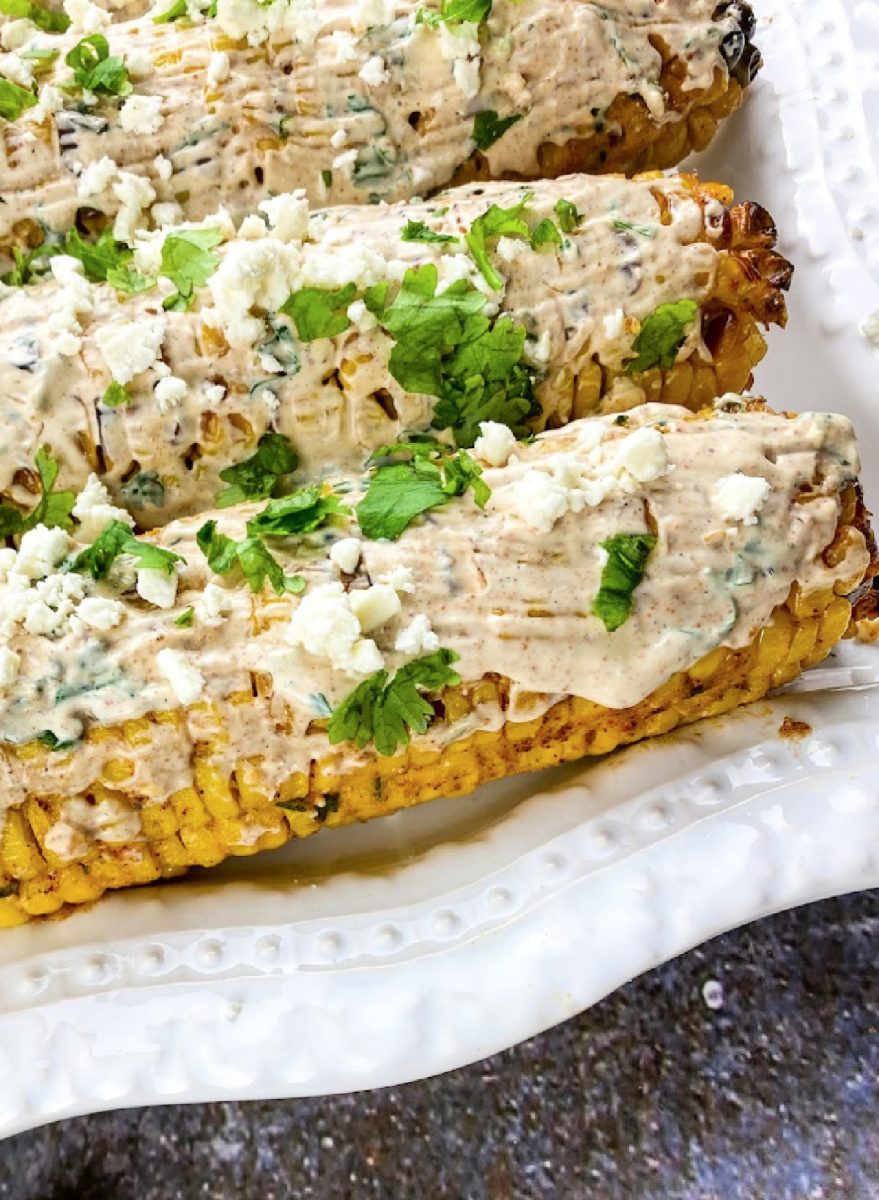 elote on white platter ready to serve