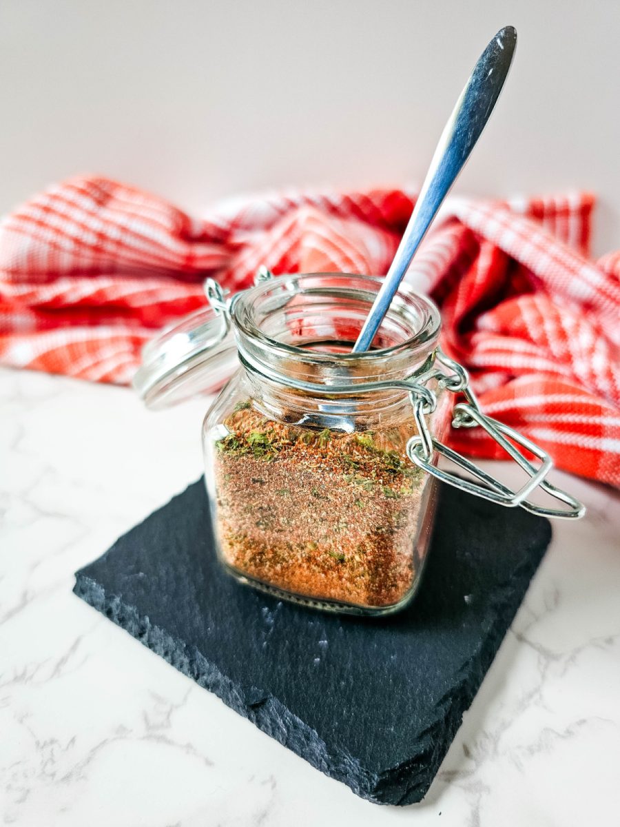 glass jar filled with a brown spice blend