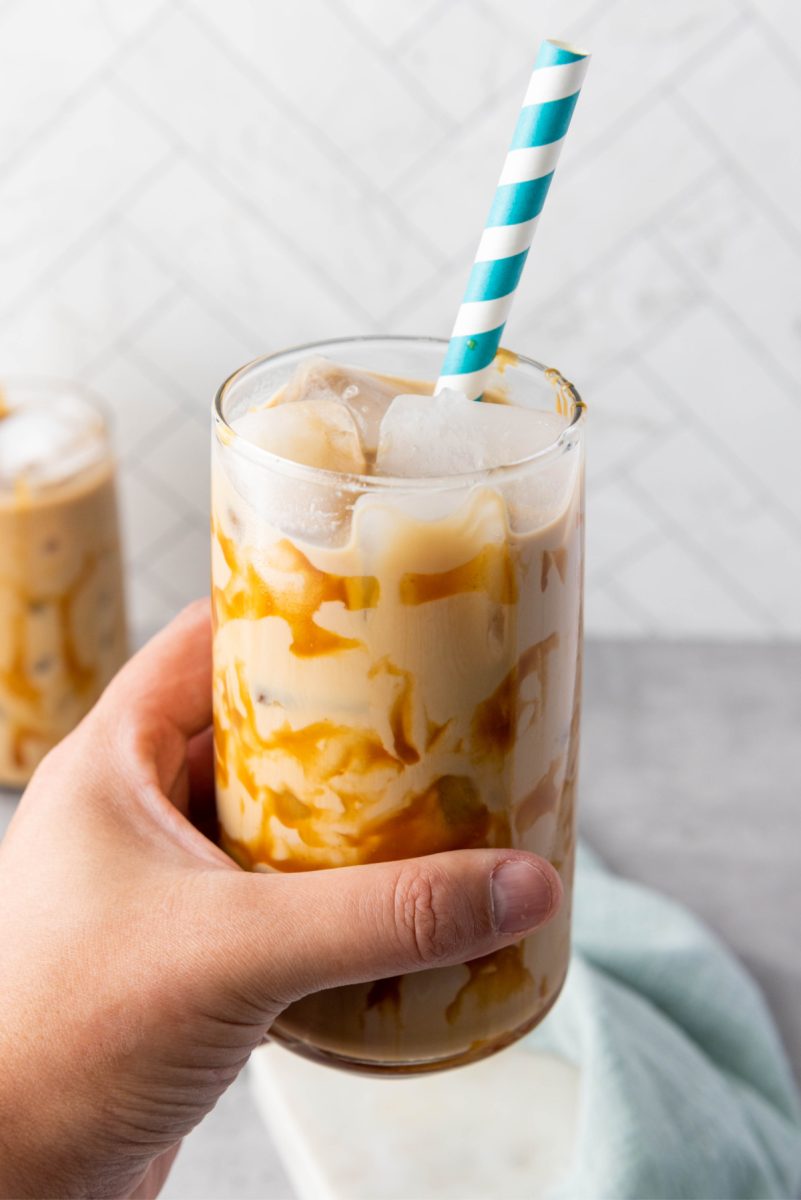 hand holding glass with coffee