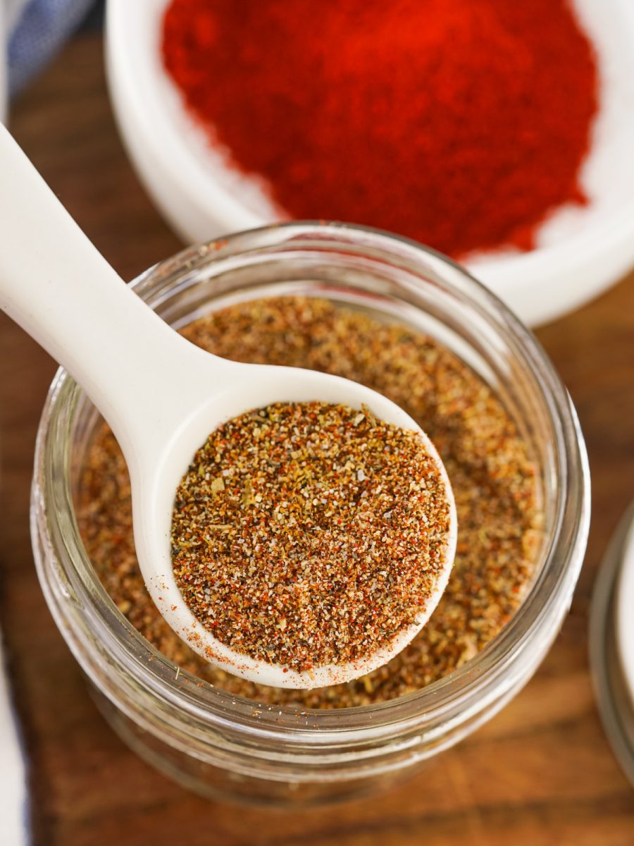 measuring spoon with taco spices in jar