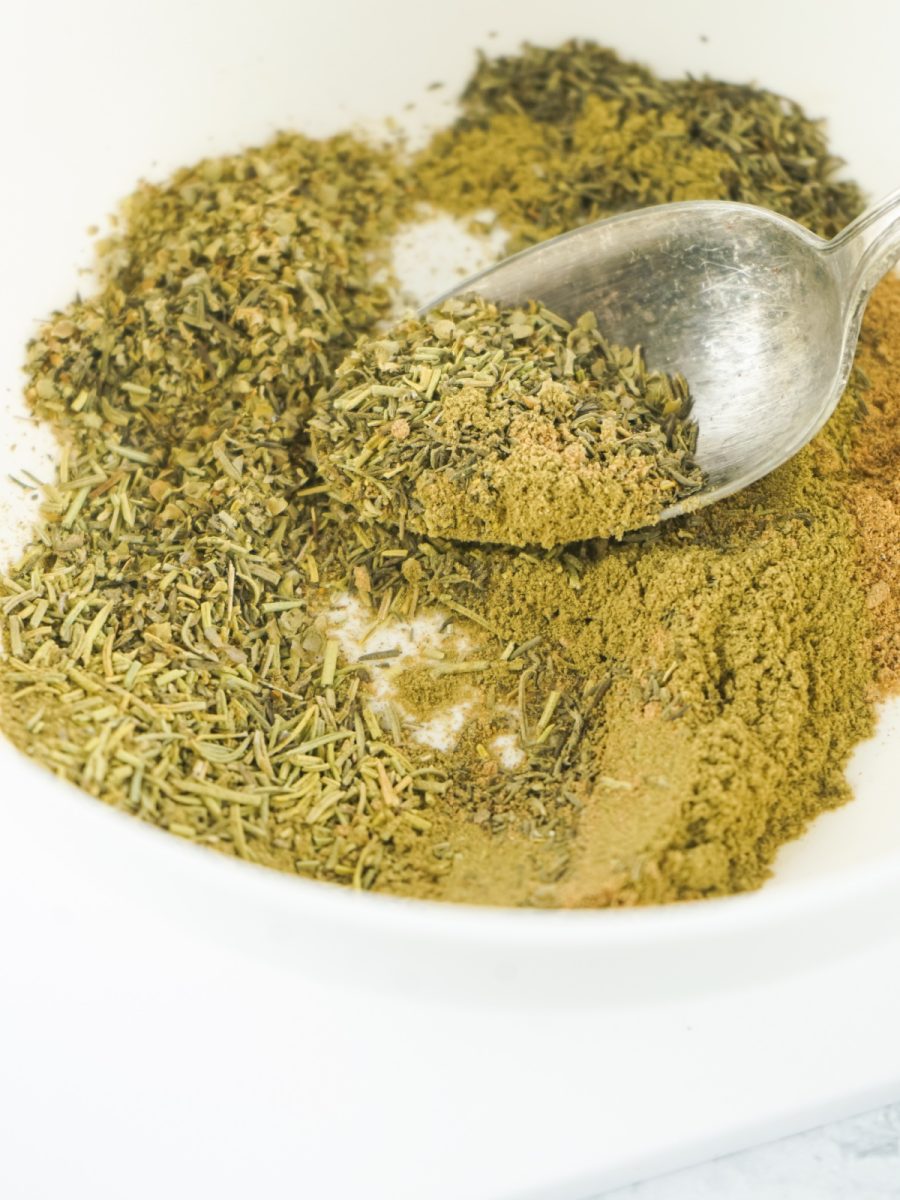 mix spices and herbs together in bowl with spoon