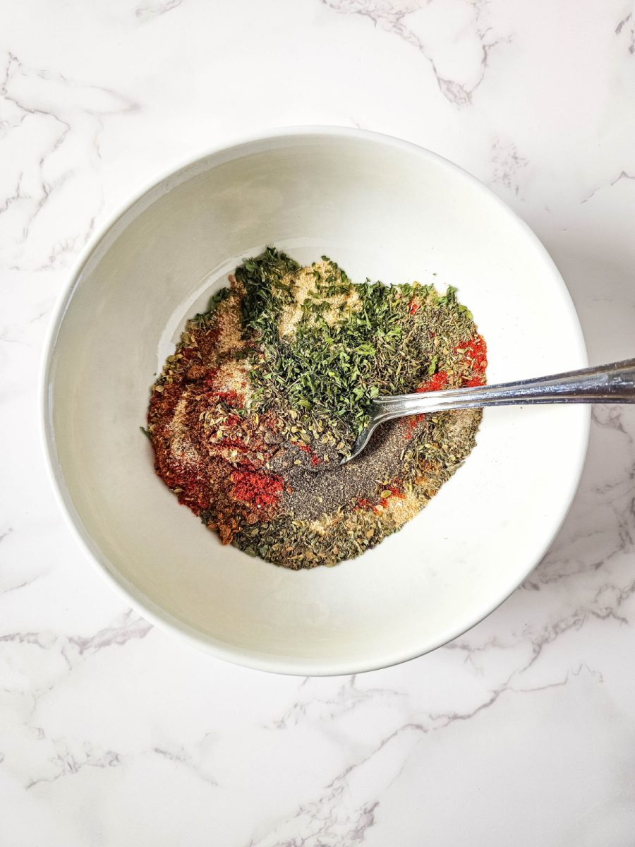 mixing the seasonings in small white bowl