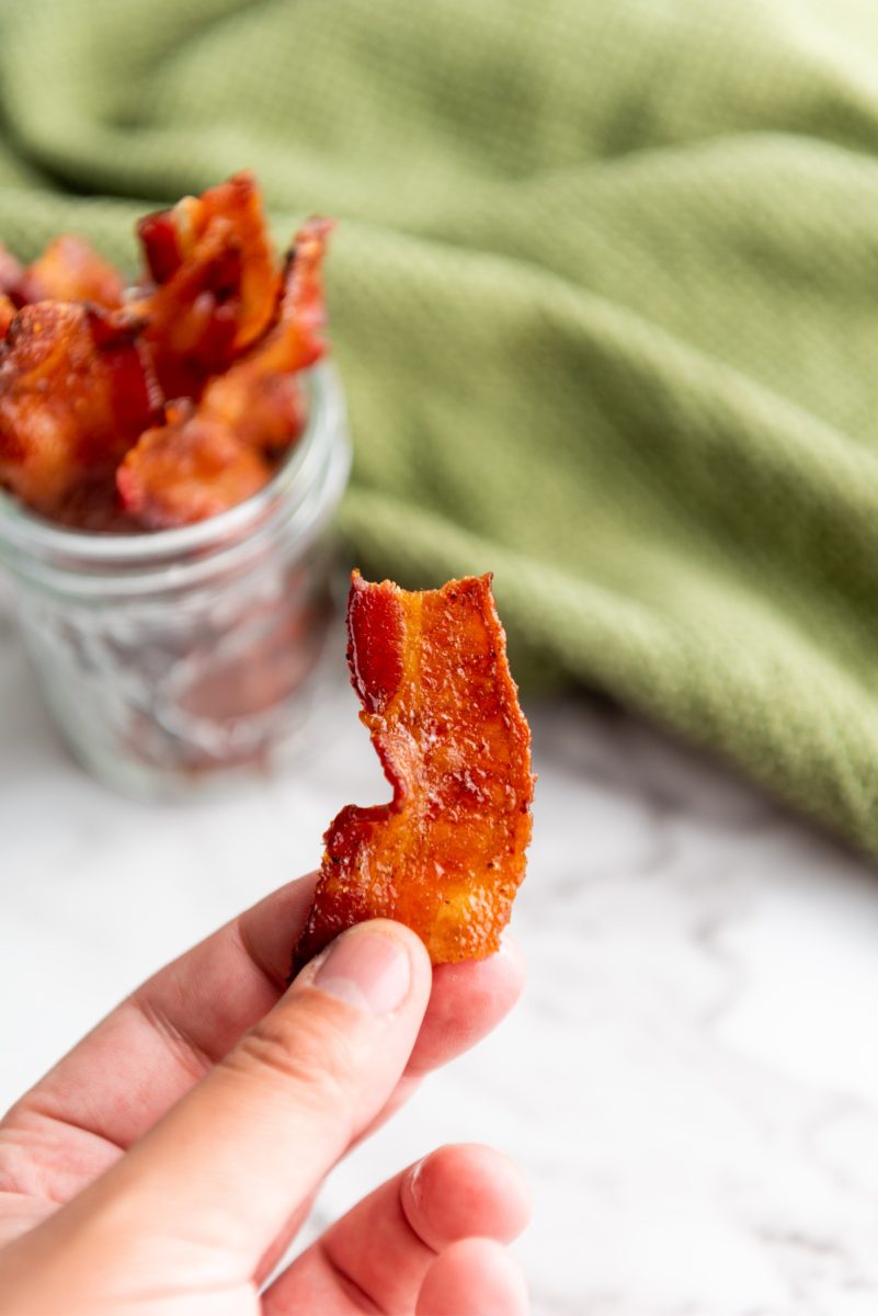 piece of bacon candy in hand