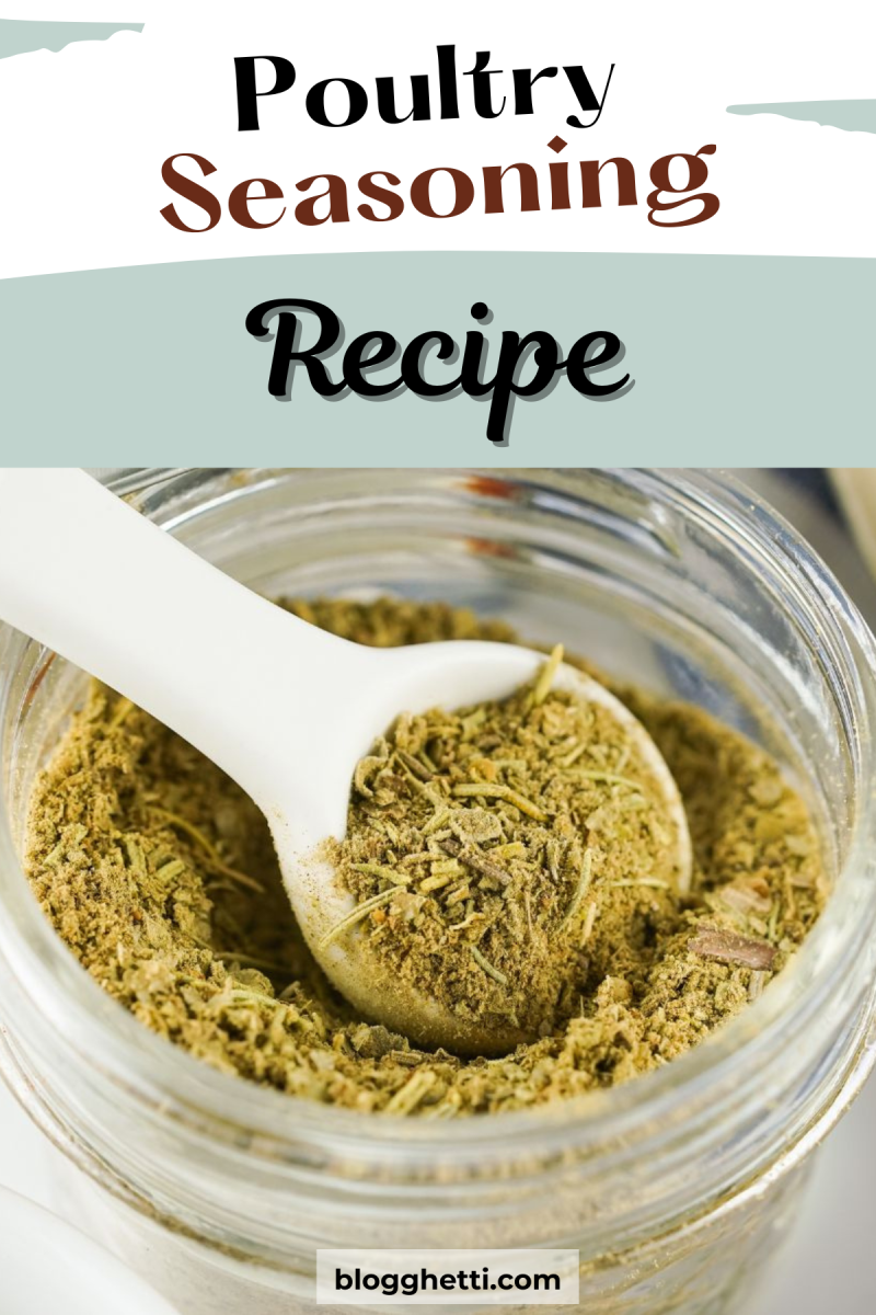 A close-up photo of a glass jar filled with homemade poultry seasoning, with a white spoon scooping some out. The seasoning is a brown mixture of herbs and spices.