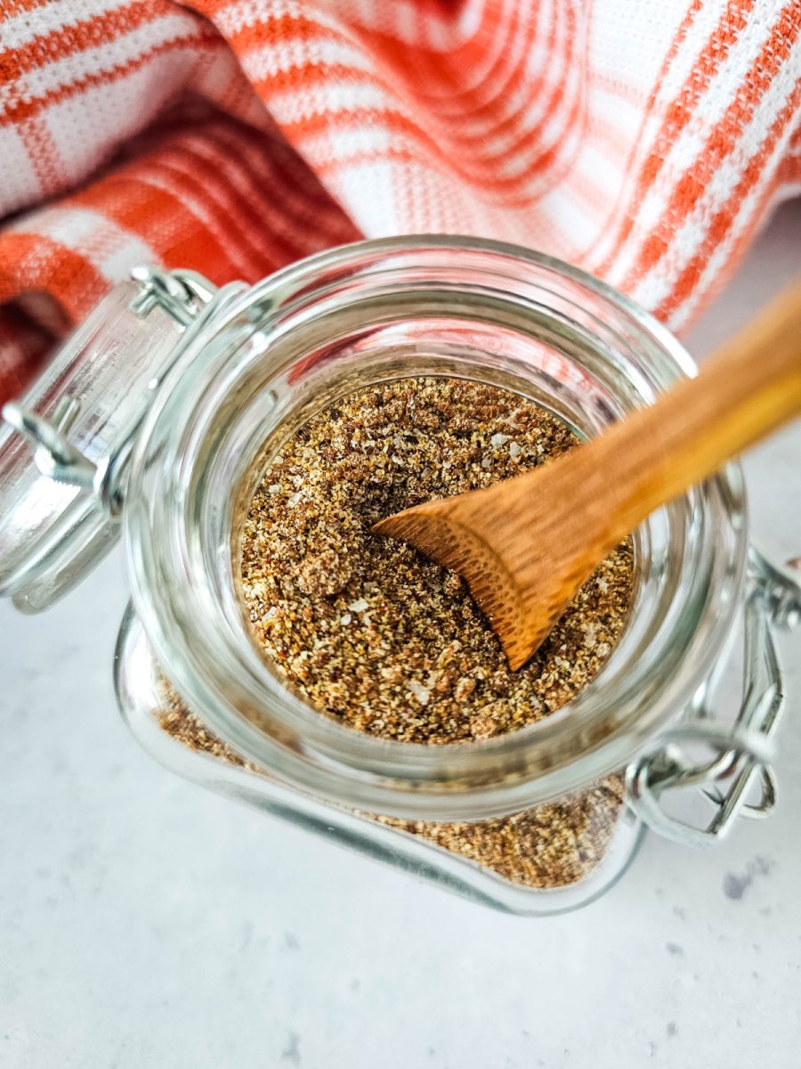 spices and herbs in jar with wooden spoon