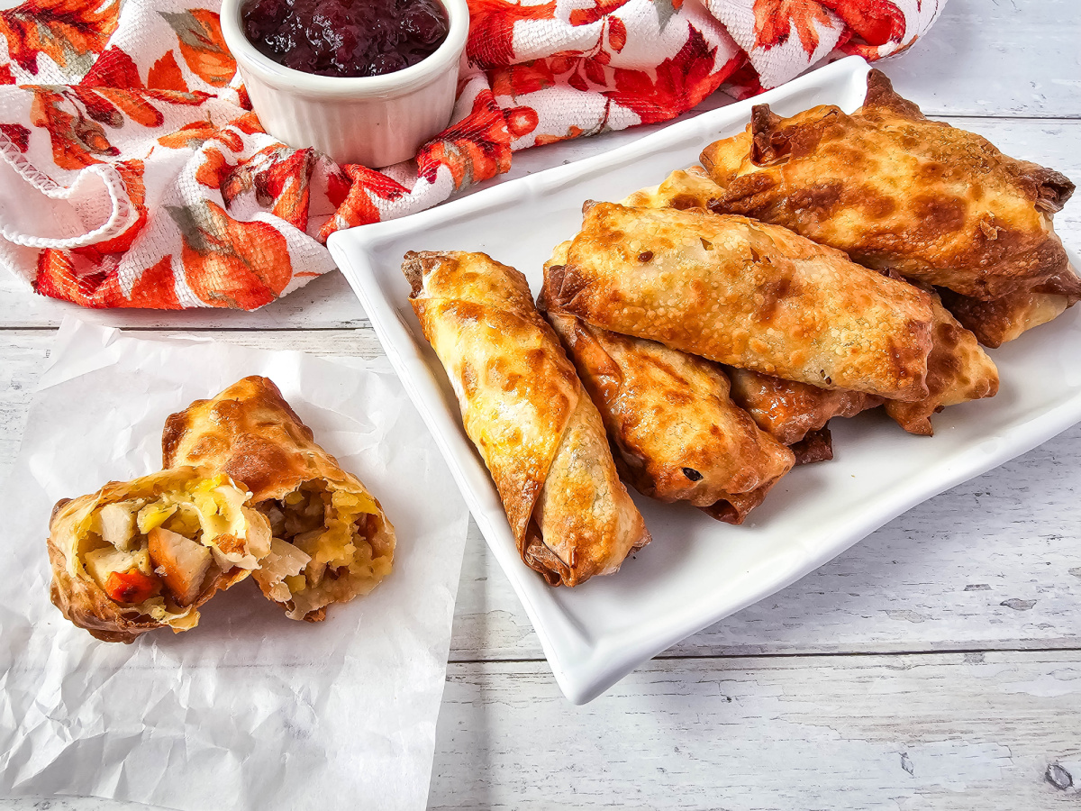 Air Fryer Thanksgiving Egg Rolls on platter with dippind sauce