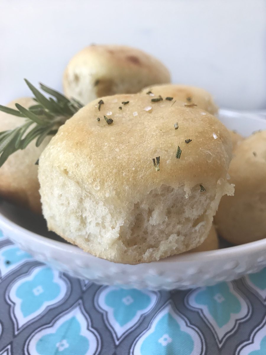 close up of dinner rolls in white bowl