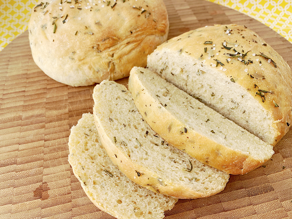 homemade bread with herbs on wooden tray