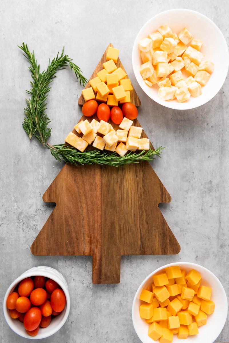 add colby cheese and rosemary sprig on tree board