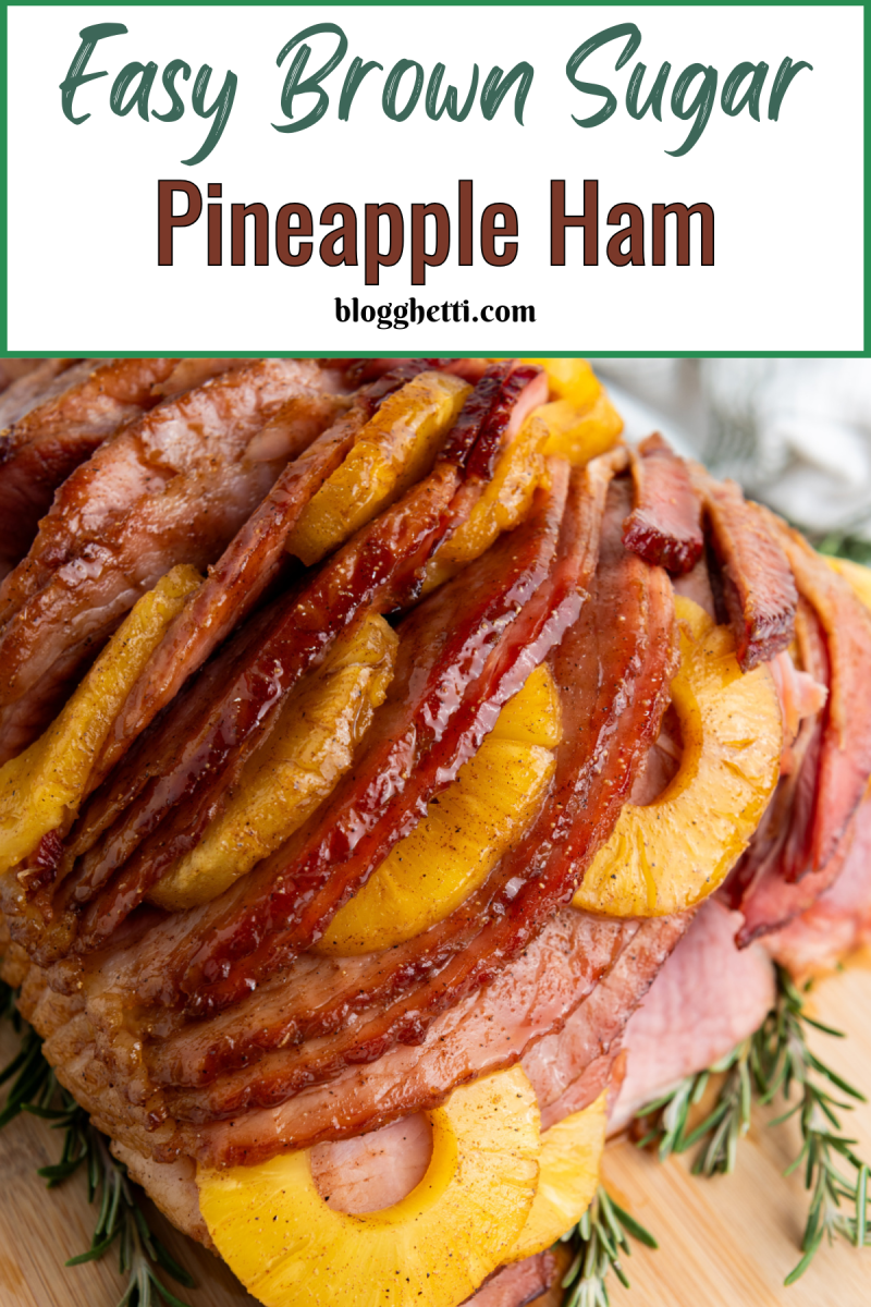 This Easy Brown Sugar Pineapple Ham in Oven brings tender ham, caramelized brown sugar, and tangy pineapple together for a perfect holiday dinner. A close-up of a glazed ham, sliced and ready to serve. Pineapple rings are nestled between the slices of ham, creating a visually appealing and delicious presentation. Rosemary sprigs are scattered around the base of the ham, adding a touch of freshness.