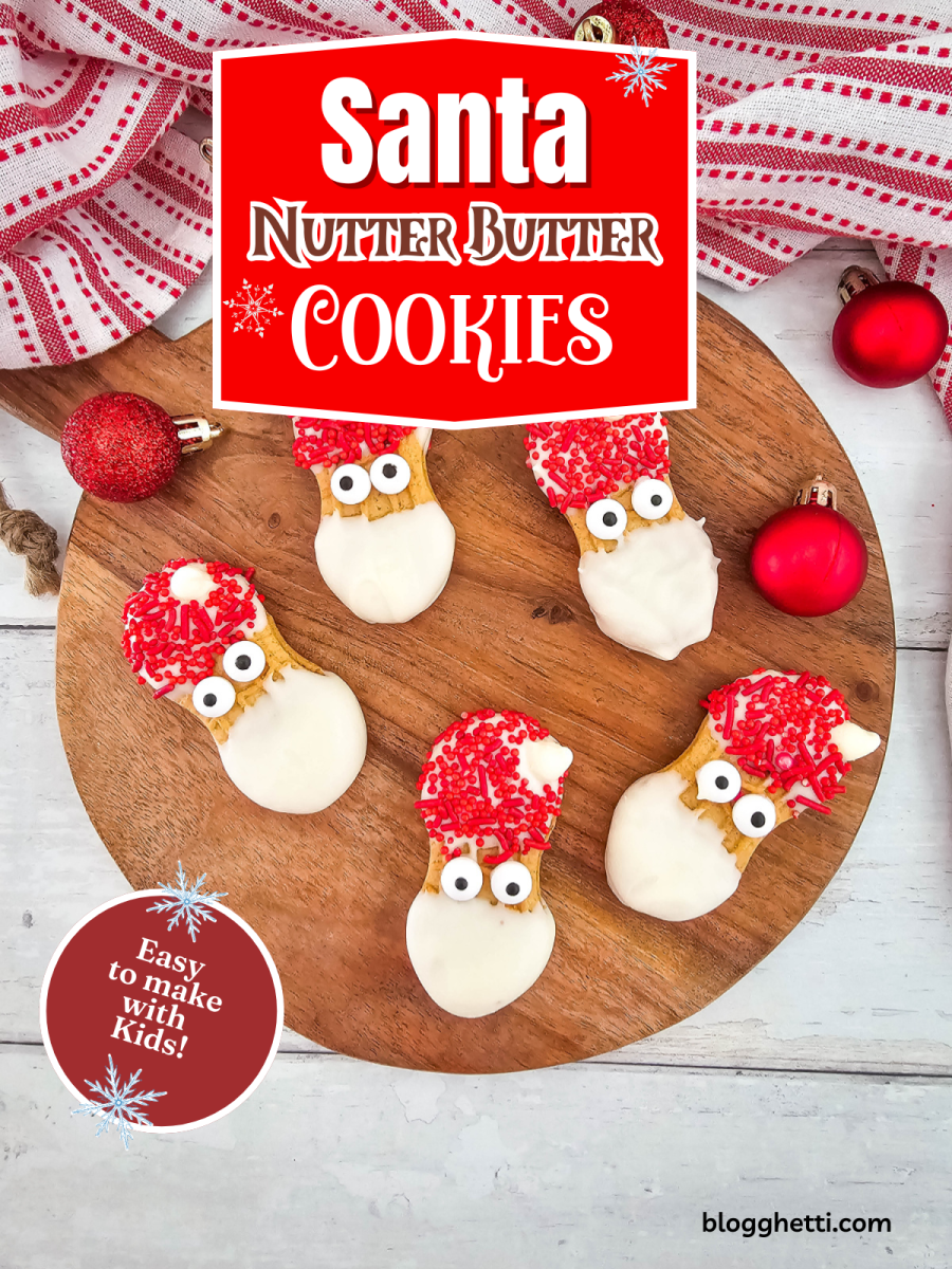 A festive platter of homemade Santa Nutter Butter cookies on a wooden board. Each cookie is decorated with white chocolate for a beard and red sprinkles for a hat.