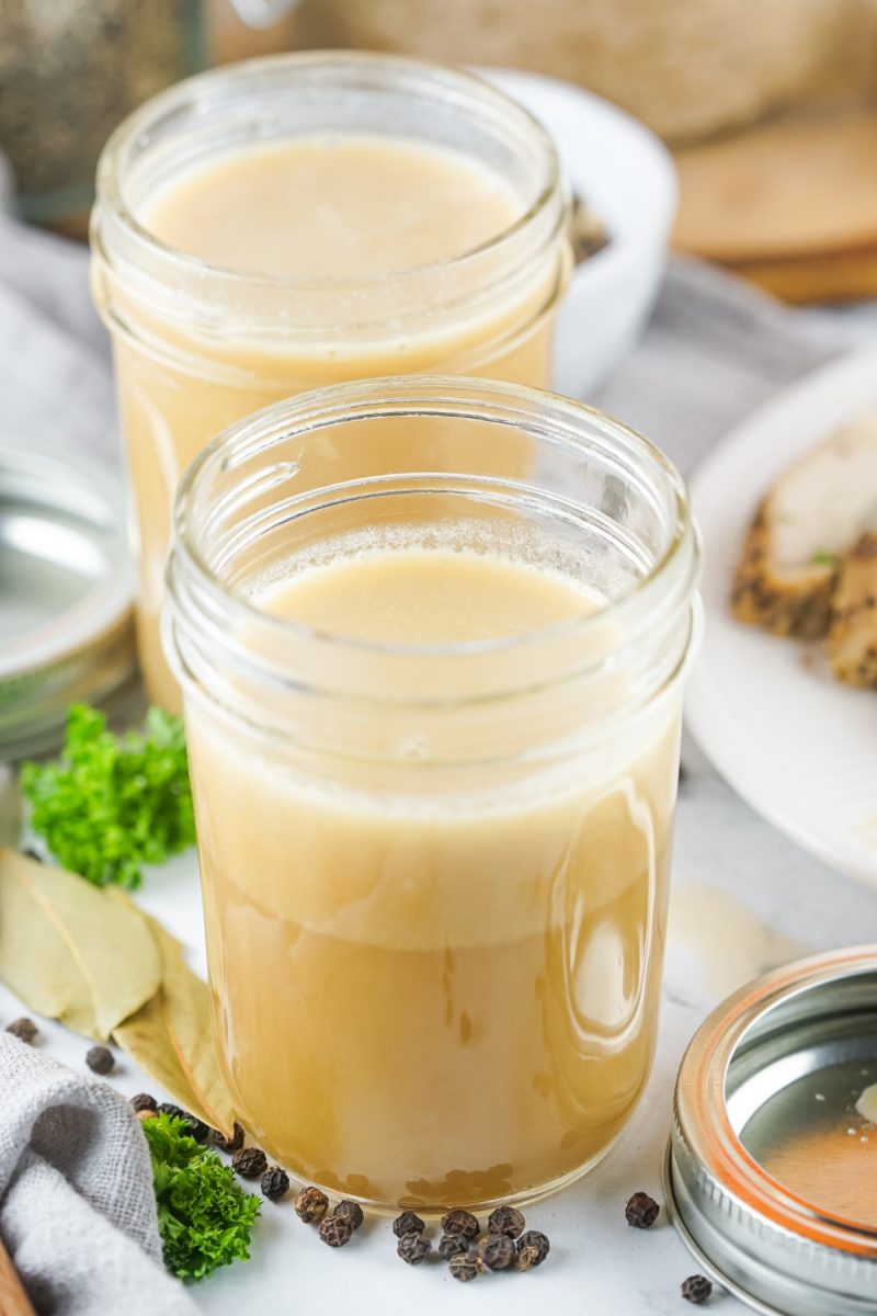 two jars filled with chicken stock