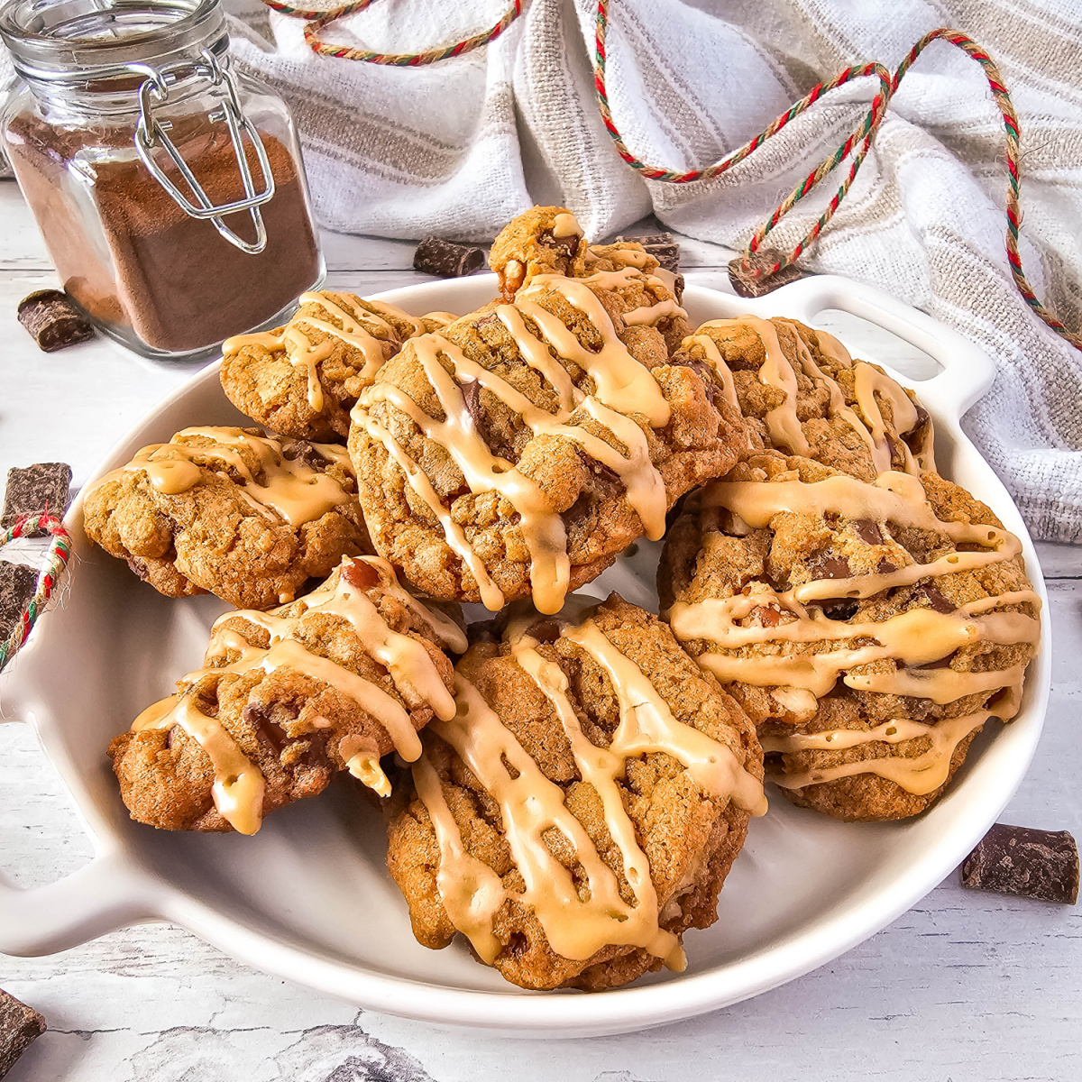 A close-up image of a plate of coffee chocolate chip cookies. The cookies are golden brown and topped with chocolate chips and a drizzle of coffee glaze.