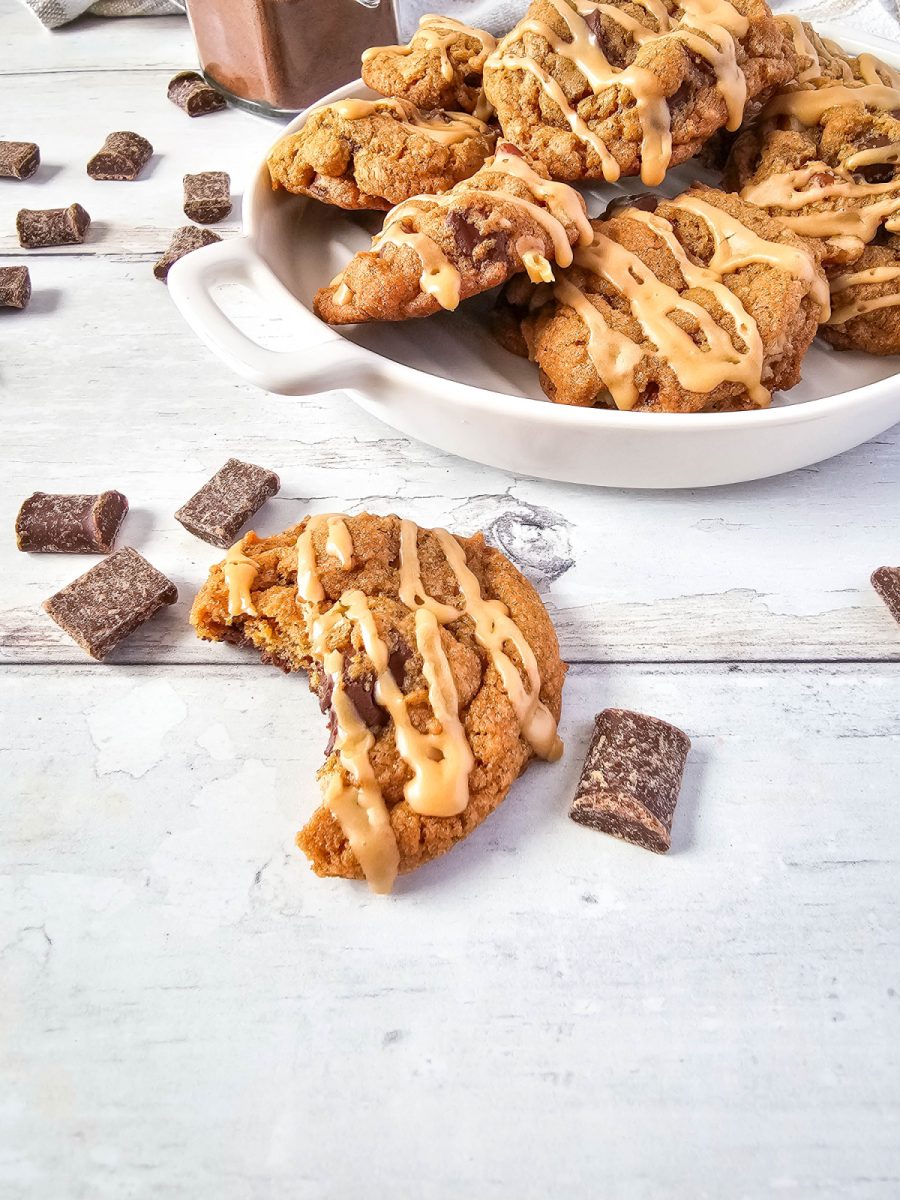 half eaten chocolate coffee cookie with a plate of them