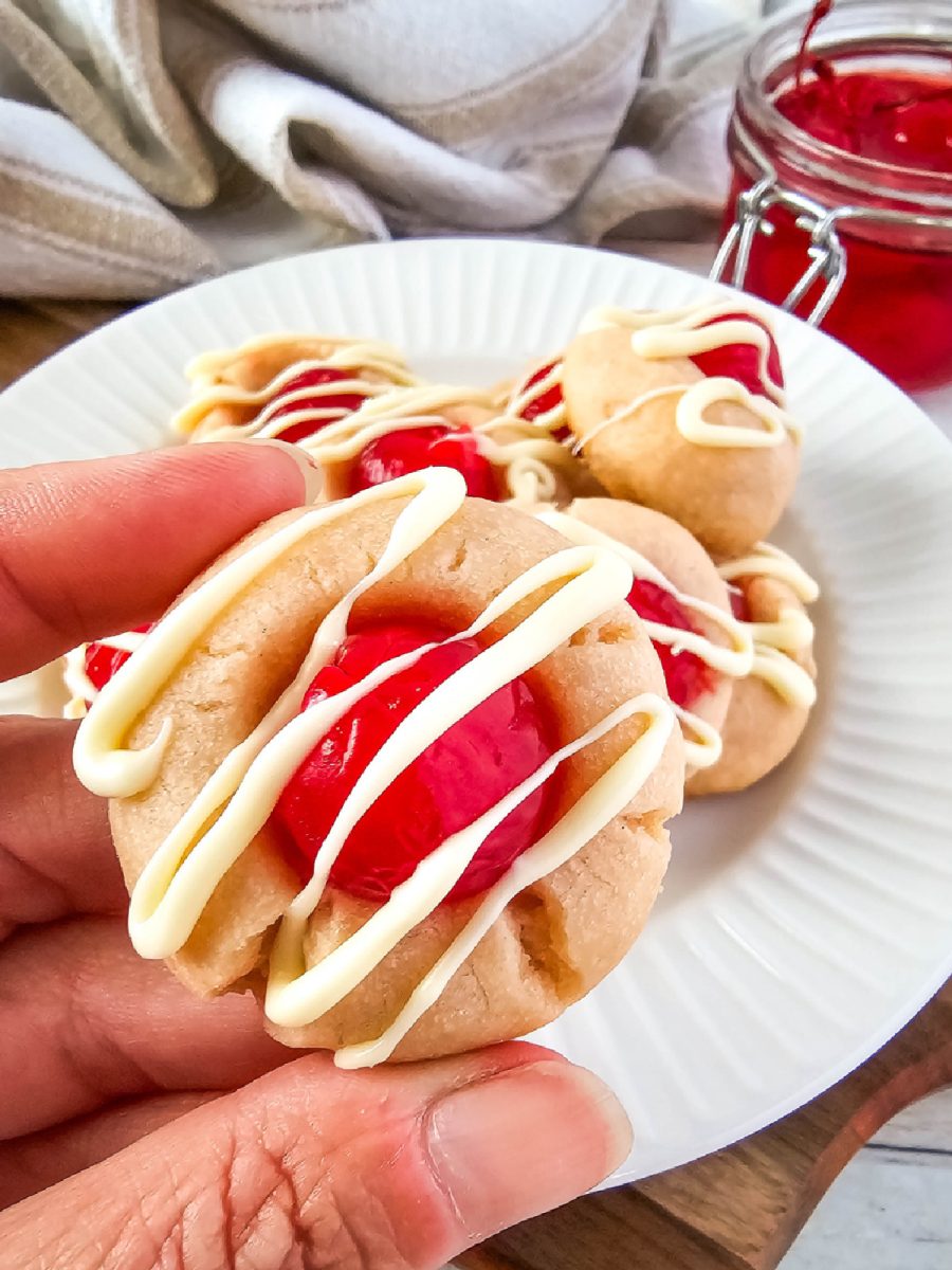 iced almond cookies in hand