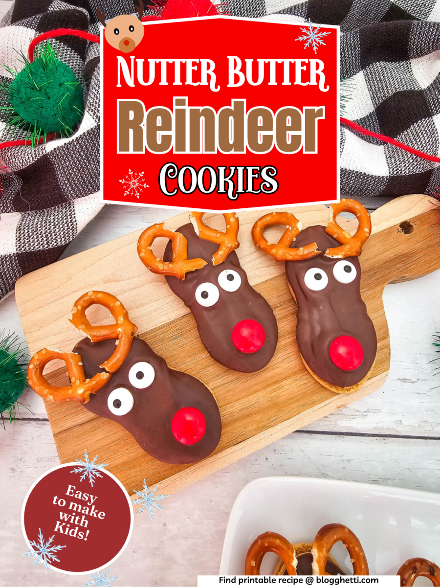 A close-up image of three Nutter Butter Reindeer Cookies on a wooden cutting board. Each cookie has chocolate frosting, candy eyes, a red nose, and pretzel antlers. The text "Nutter Butter Reindeer Cookies" is displayed in a festive red banner above the cookies. The phrase "Easy to make with kids!" is written in white text on a red background in the bottom left corner.