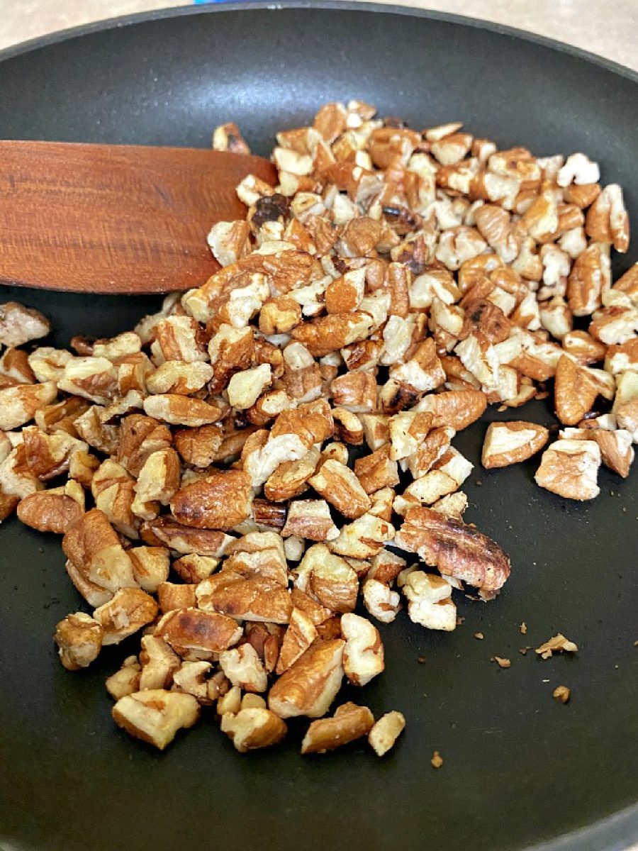 pecans toasting in skillet