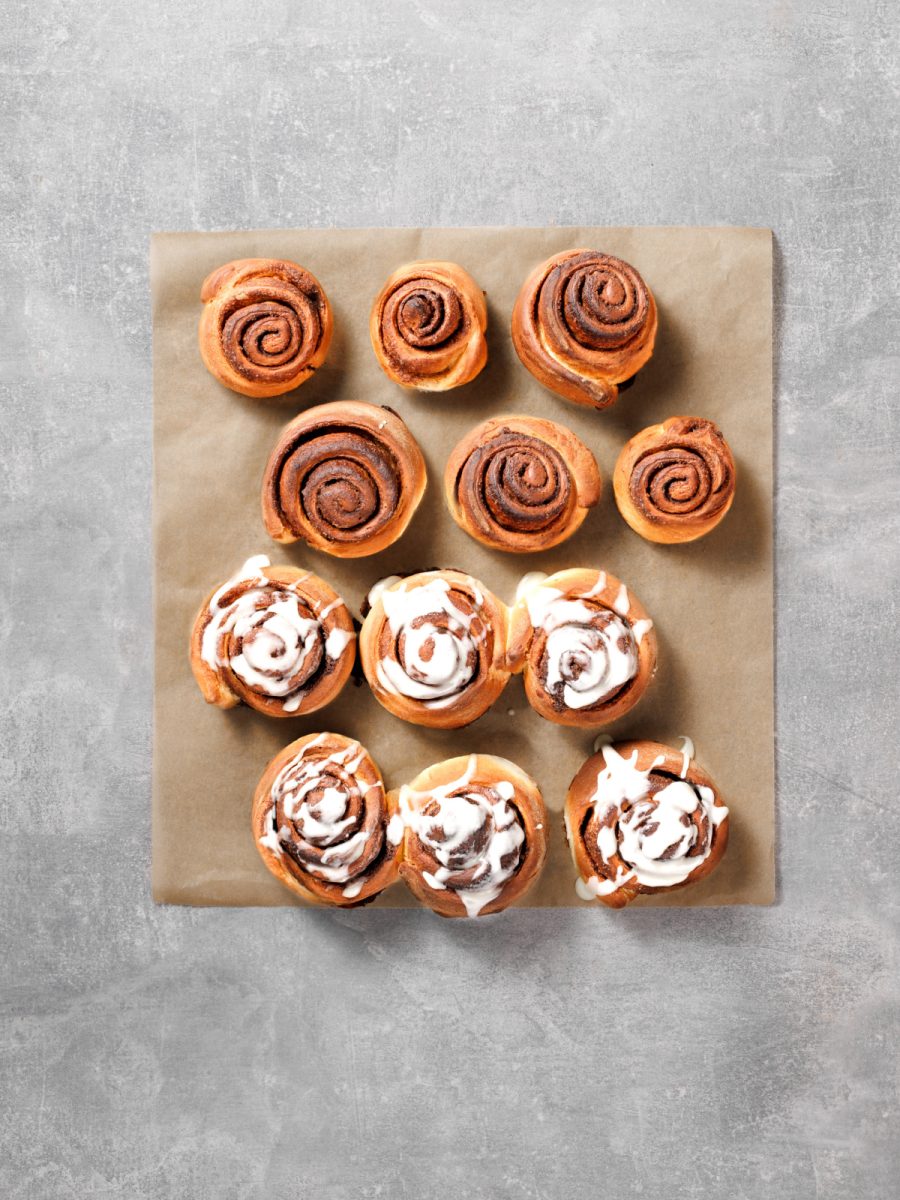 spread cream cheese glaze on rolls