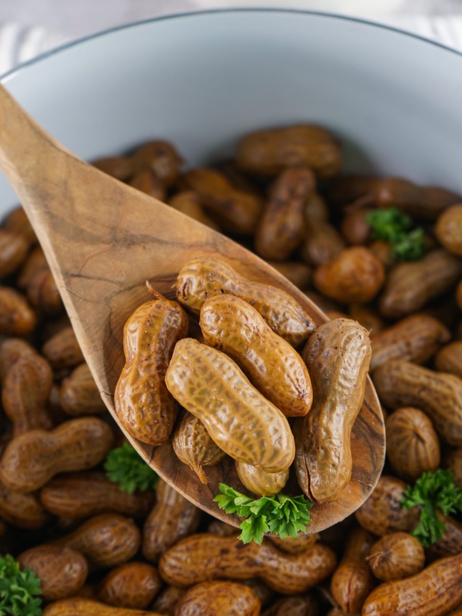 wooden spoon with nuts and pot in background