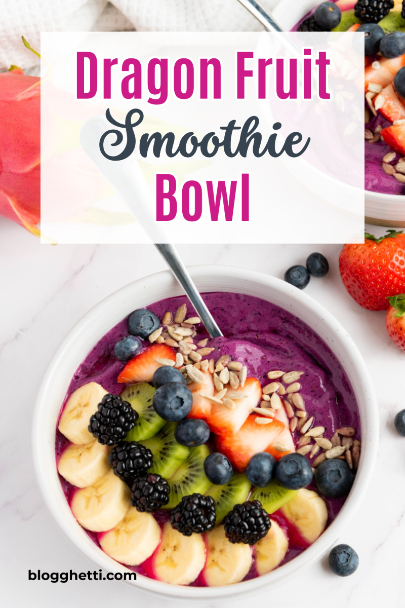 A vibrant purple dragon fruit smoothie bowl topped with sliced banana, kiwi, blackberries, blueberries, strawberries, and pumpkin seeds