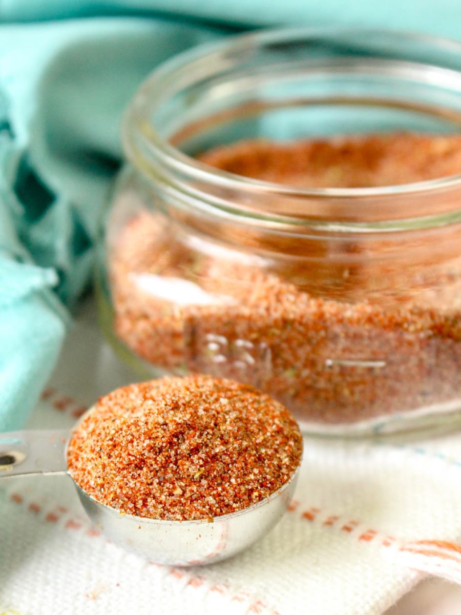 close up of bbq seasoning in measuring spice with jar