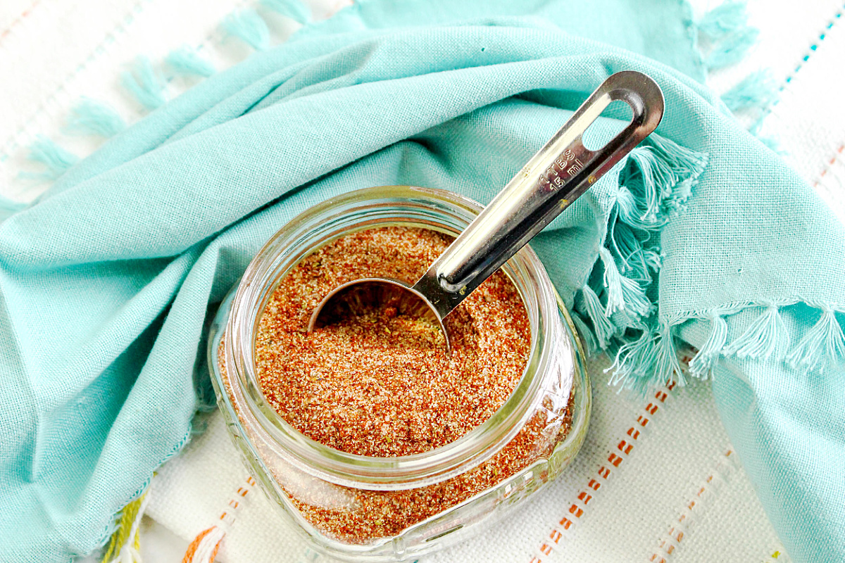 measuring spoon in jar of spices for meat