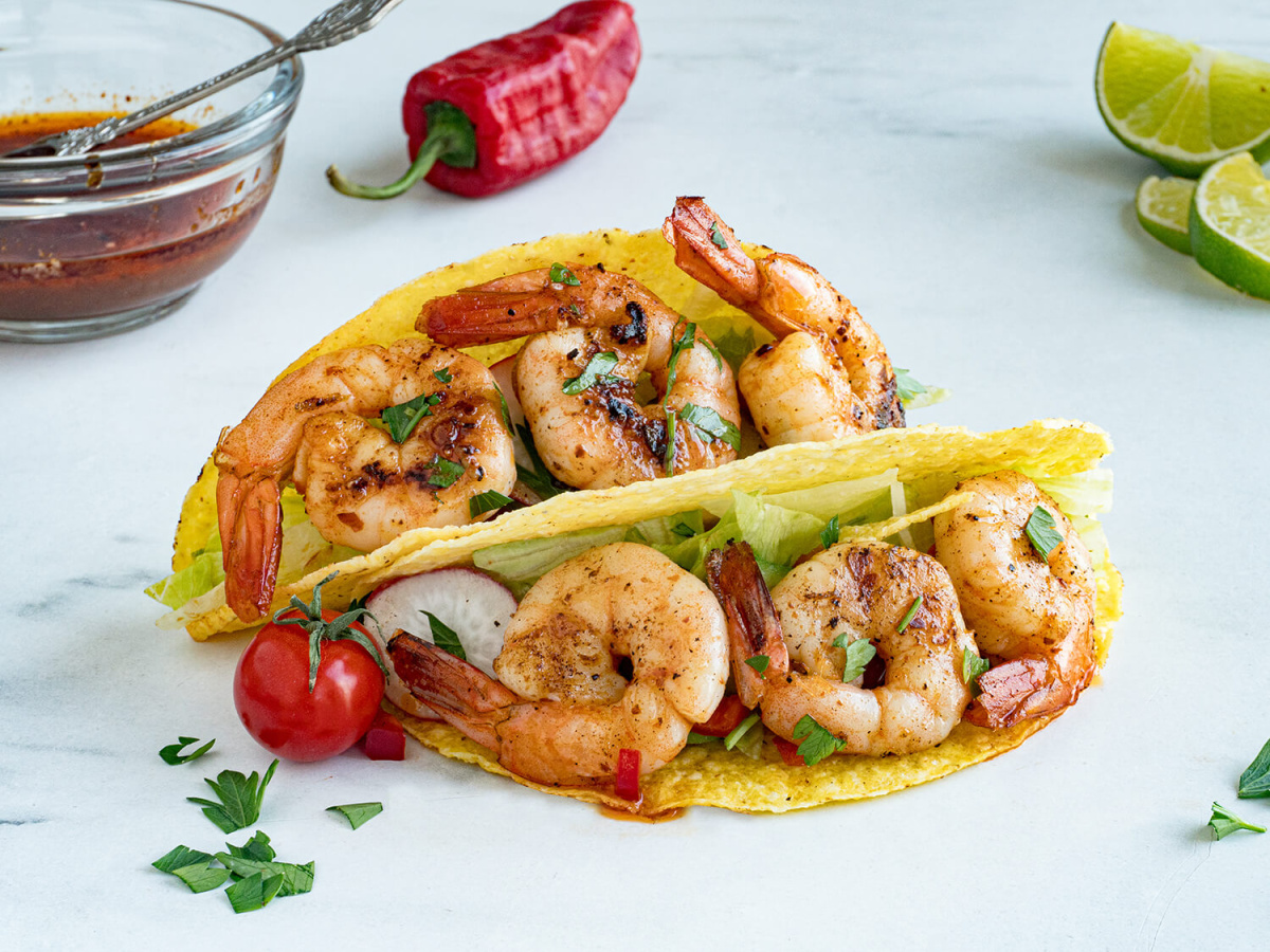two shrimp tacos with lettuce