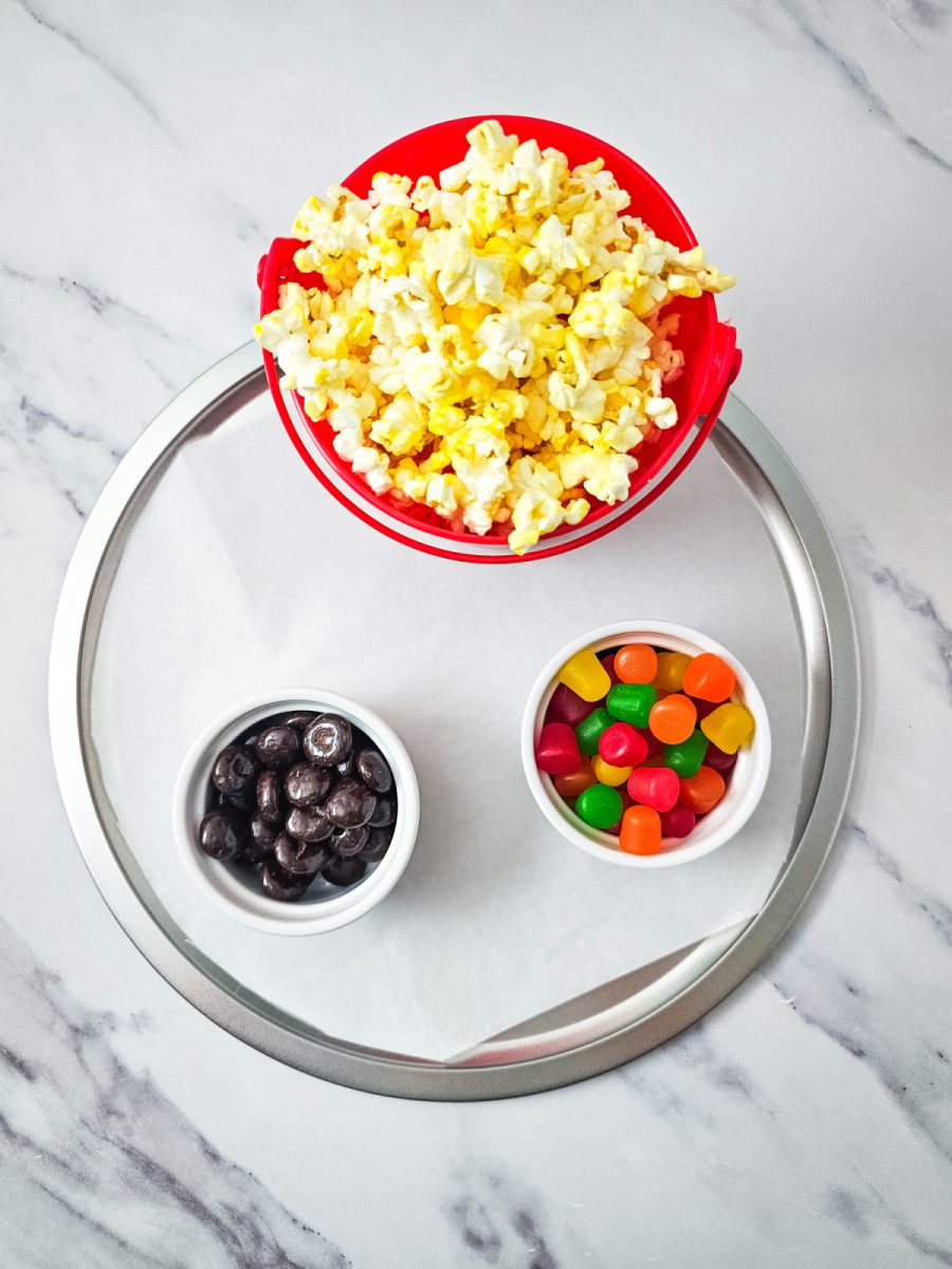tray with popcorn and small bowls of candy