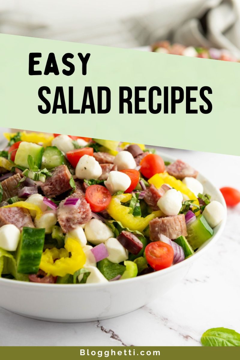 A colorful salad in a white bowl filled with lettuce, cherry tomatoes, small mozzarella balls, yellow bell pepper slices, red onion, cucumber pieces, and chunks of salami or similar cured sausage. Green overlay text reads "EASY SALAD RECIPES."