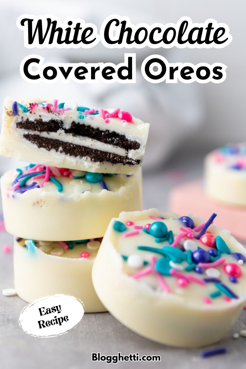 A stack of two white chocolate covered Oreos with colorful sprinkles, with the top cookie cut in half revealing the black Oreo cookie inside. Another full white chocolate covered Oreo rests in front of the stack. Text overlaid on the image reads "White Chocolate Covered Oreos