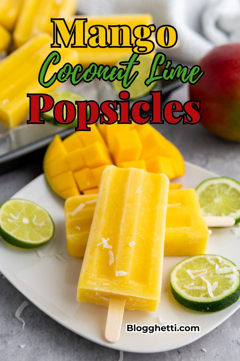 A plate of bright yellow mango coconut lime popsicles, garnished with lime slices and shredded coconut, with a whole mango in the background. The text "Mango Coconut Lime Popsicles" is overlaid in colorful fonts