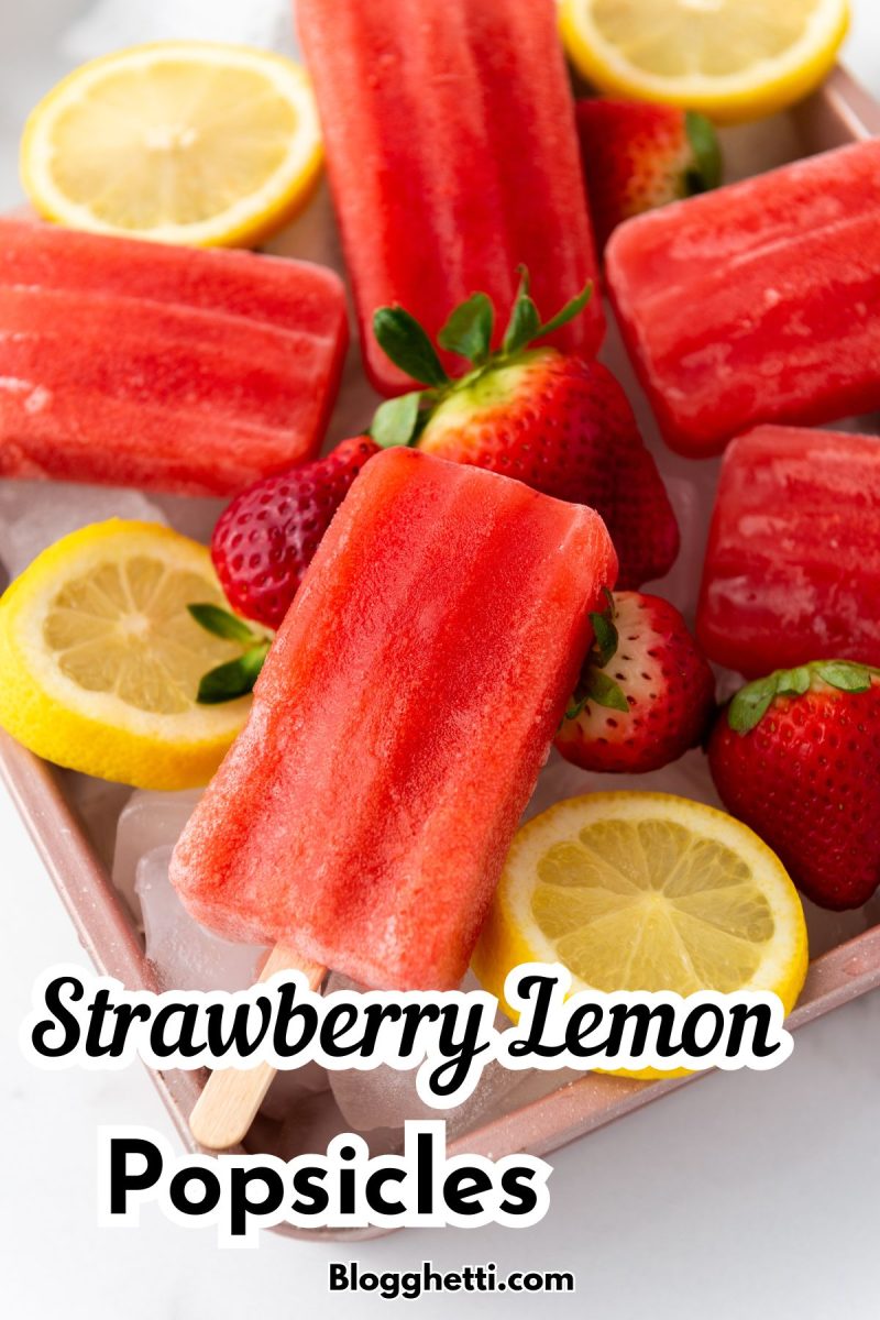 Several vibrant red strawberry lemon popsicles are arranged on a light pink tray filled with ice, surrounded by fresh strawberries and lemon slices. The text "Strawberry Lemon Popsicles" is prominently displayed in the center with "Blogghetti.com" at the bottom.