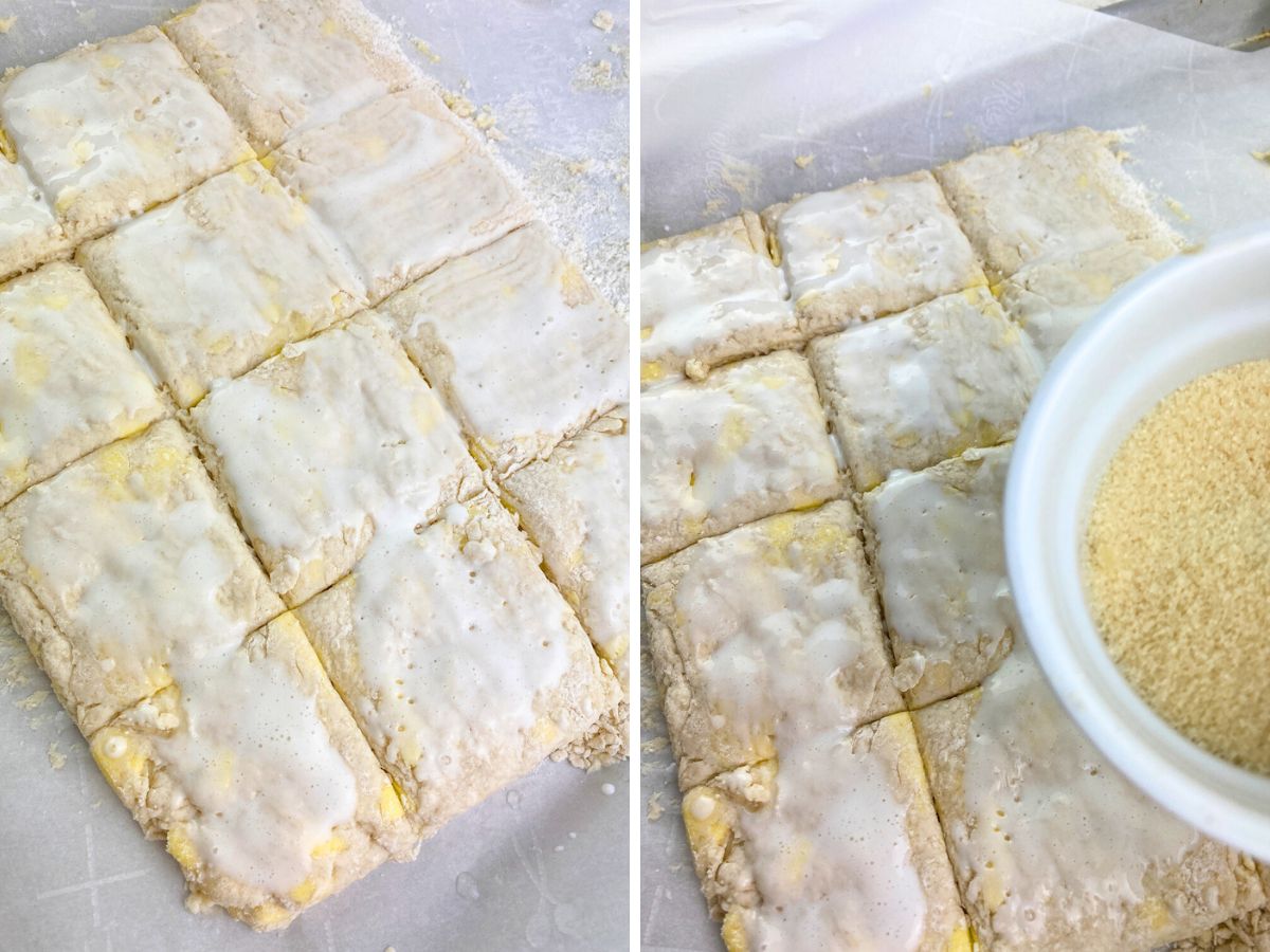 A split image showing the final preparation of the biscuit dough before baking. The left side shows a brush applying a milk wash to the top of the biscuit dough squares. The right side shows a bowl of raw sugar being held over the milk-brushed dough, ready to be sprinkled on top.