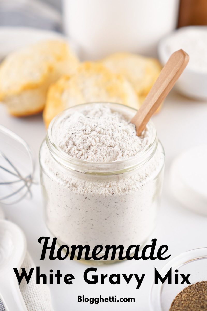 Vertical image of the jar of white gravy mix with a wooden spoon. Large script text overlays read "Homemade White Gravy Mix" with a Blogghetti.com URL at the bottom.