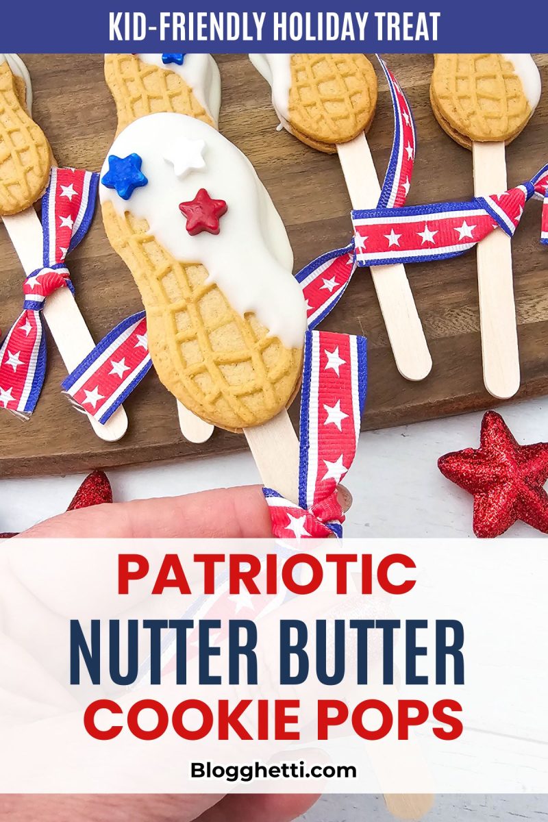 A row of patriotic nutter butter cookie pops dipped in white chocolate and topped with red and blue star sprinkles sits on a wooden serving board. The bottom half features a bold white text block displaying the recipe title for red, white, and blue nutter butter cookie pop