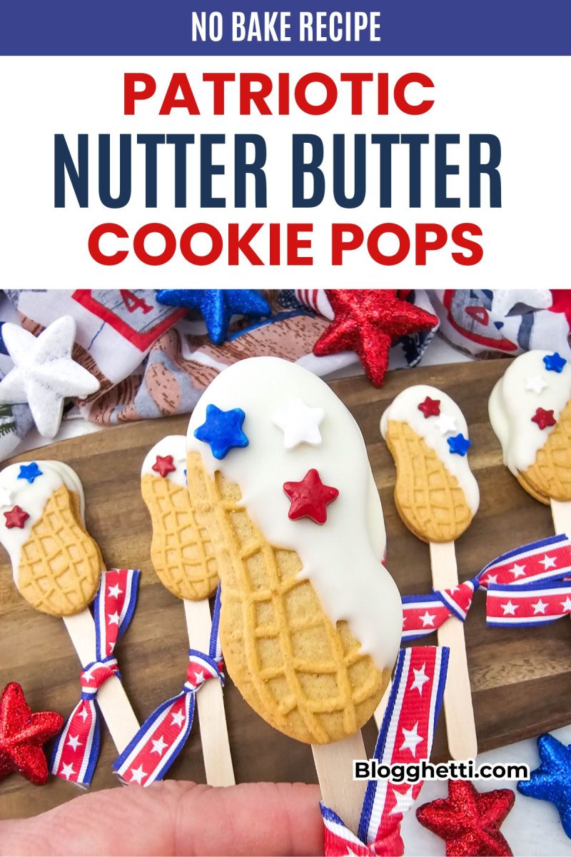 A hand holds a festive red, white, and blue nutter butter cookie pops treat decorated with white chocolate and star sprinkles. The background features more patriotic nutter butter cookie pops with star ribbons on a wooden tray with a dark blue headline text banner at the top.