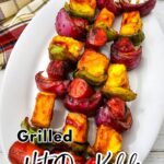 Pinterest pin featuring grilled hot dog kabobs with grilled vegetables and pineapple served on a white platter. The design includes the recipe title, "Easy BBQ Dinner," and the Blogghetti website.