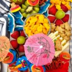 Pinterest graphic for a pool party charcuterie board made with easy grocery store favorites for summer entertaining.