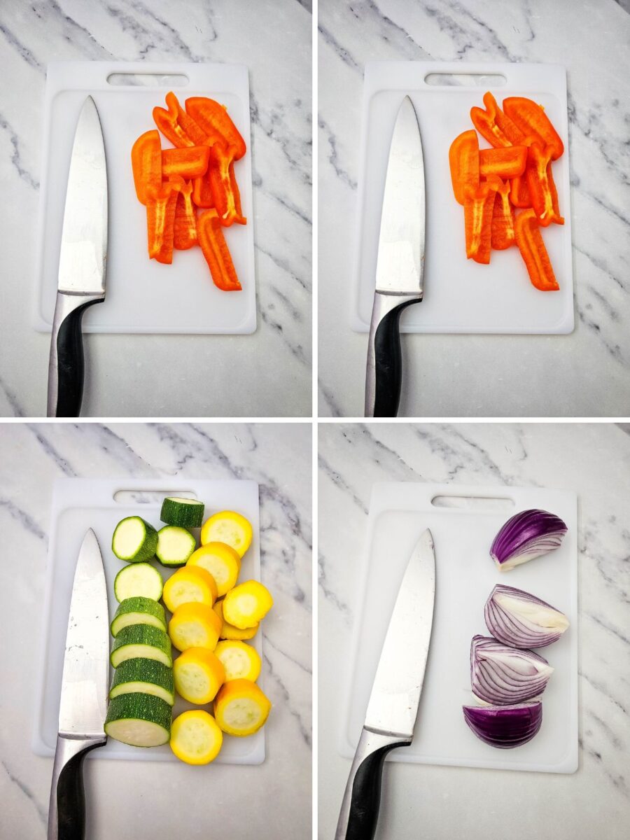 Bell peppers, zucchini, summer squash, and red onion sliced on a cutting board before making grilled vegetables.