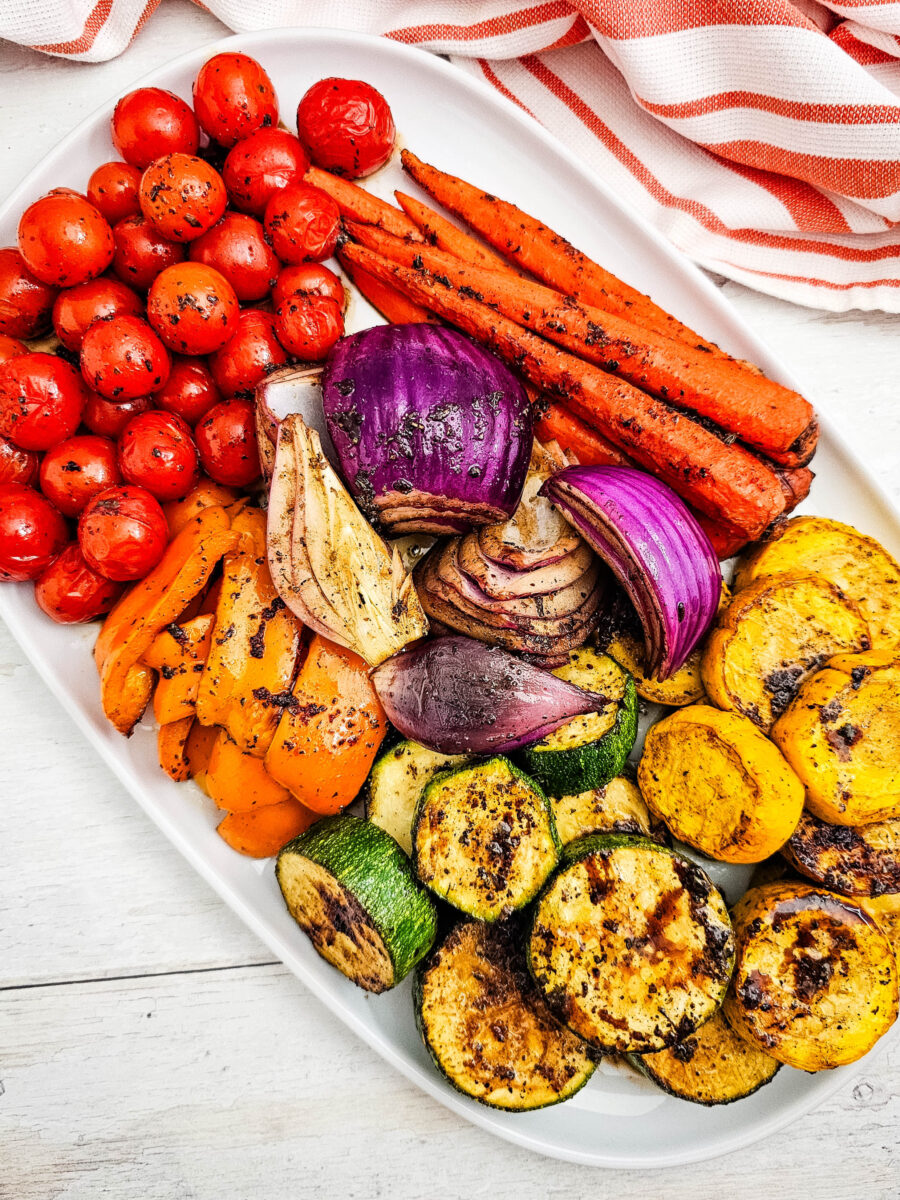 Healthy grilled side dish served on a white platter with vibrant colors and charred edges.